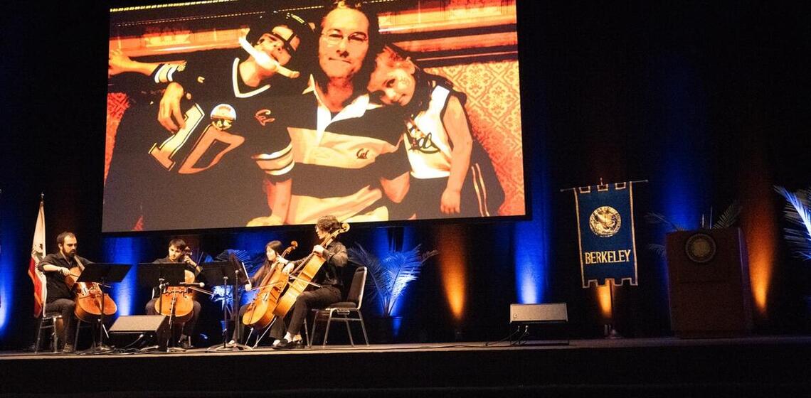 cal orchestra performing during a presentation that feature images of rich lyons